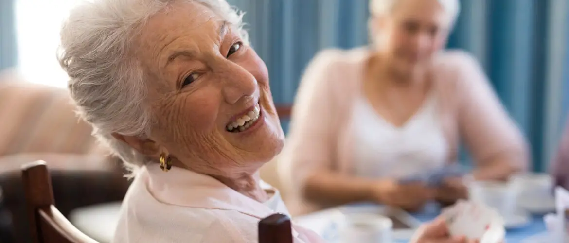 Senior women playing One Must Go and laughing