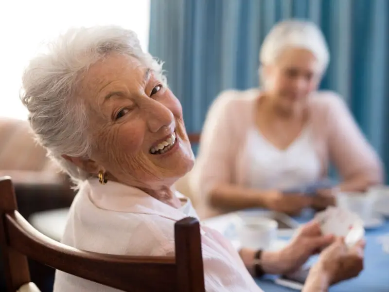 Senior women playing One Must Go and laughing