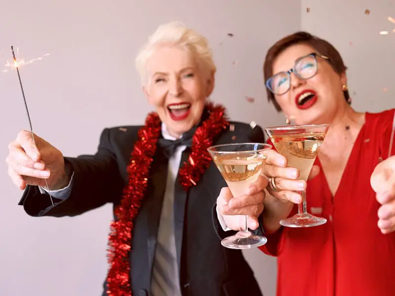 Two energetic senior women with cocktails