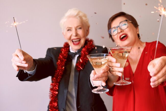 Two energetic senior women with cocktails