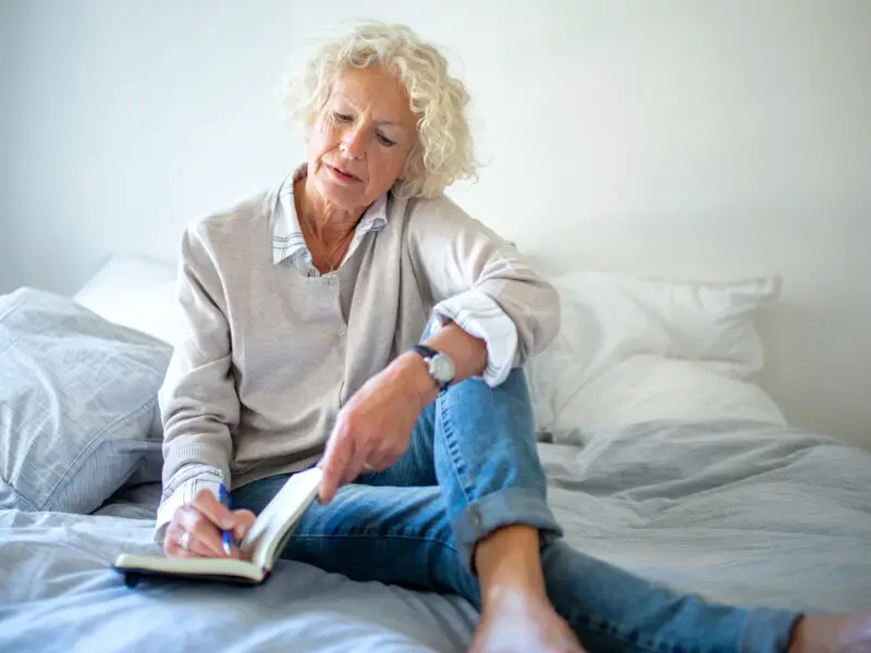 Woman in her 60s writing resolutions