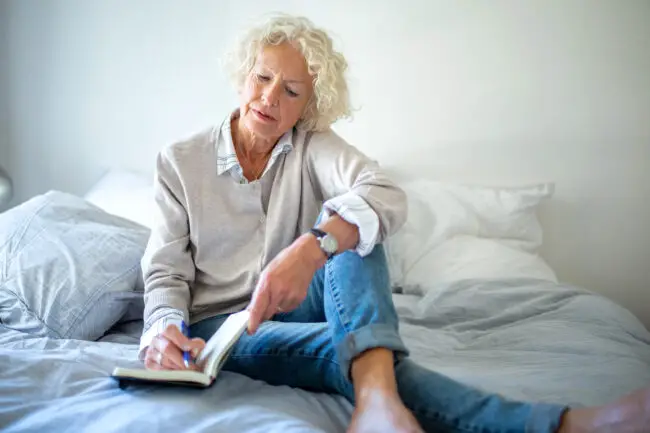 Woman in her 60s writing resolutions